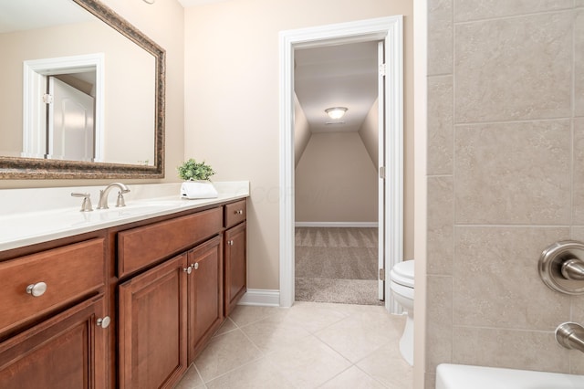 bathroom featuring vanity, tile patterned flooring, a bathing tub, and toilet