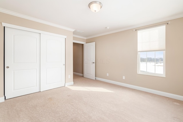 unfurnished bedroom with crown molding and a closet