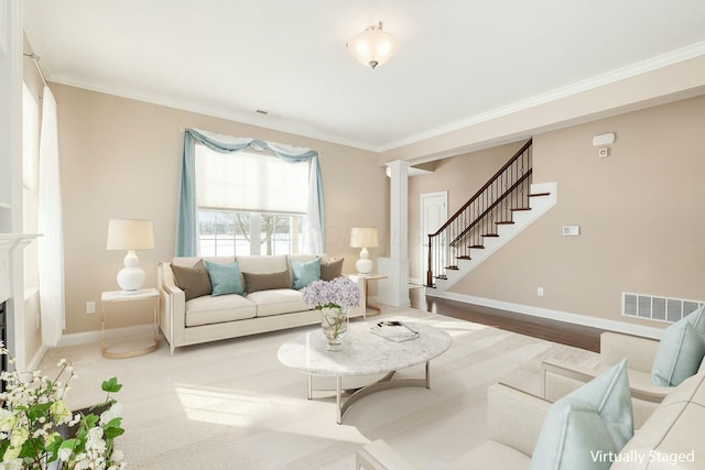 living room with ornate columns and ornamental molding