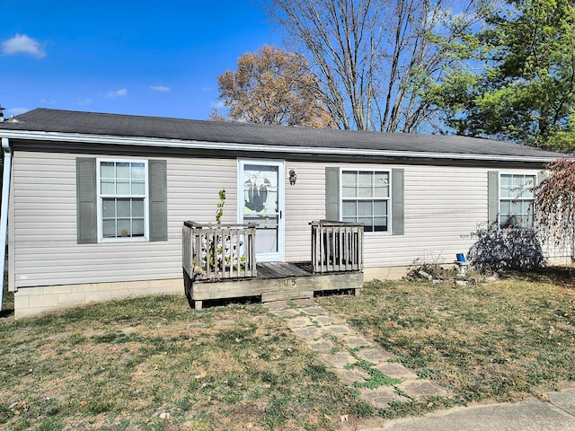 view of front facade featuring a front yard and a deck