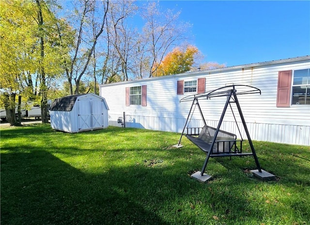 back of house with a lawn and a storage unit