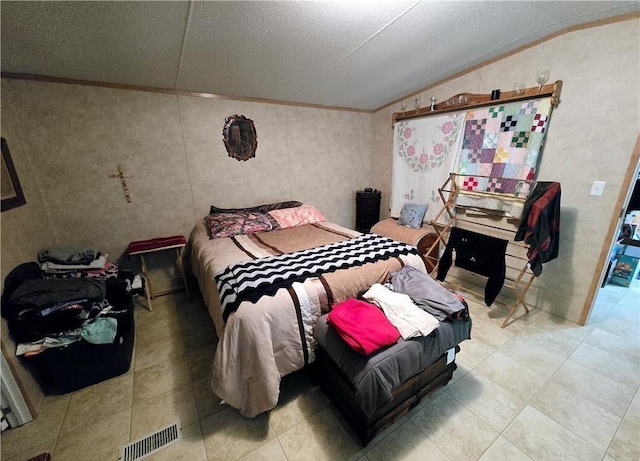 bedroom featuring a textured ceiling, vaulted ceiling, and ornamental molding