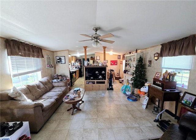 tiled living room with ceiling fan and plenty of natural light