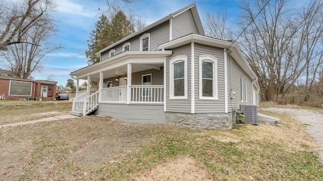 view of front of property with central AC and a porch