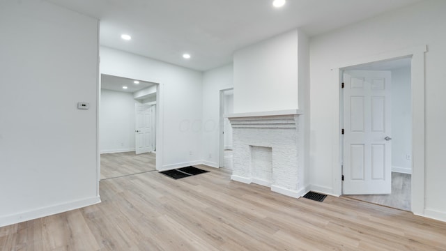 unfurnished living room with light hardwood / wood-style floors