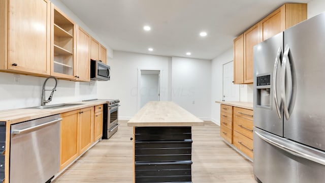 kitchen featuring light brown cabinetry, sink, wooden counters, and appliances with stainless steel finishes