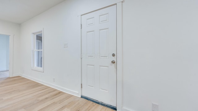 foyer entrance with light hardwood / wood-style floors