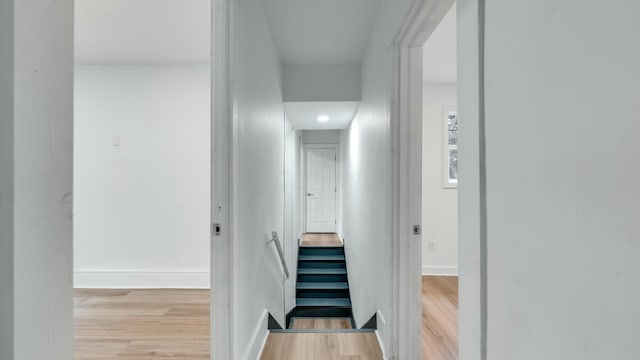 corridor with light hardwood / wood-style floors