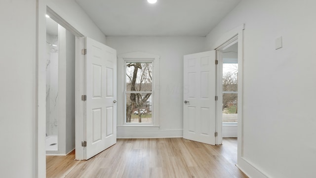 doorway with a wealth of natural light and light wood-type flooring