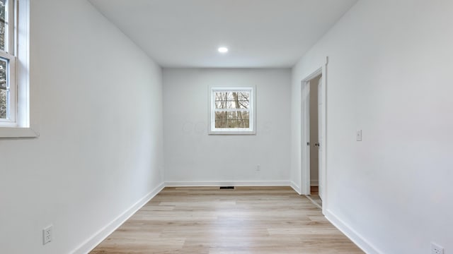 empty room with light hardwood / wood-style flooring