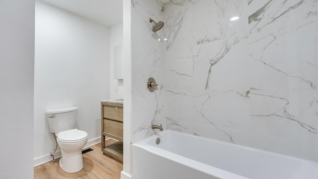 full bathroom featuring vanity, toilet, tiled shower / bath combo, and hardwood / wood-style floors