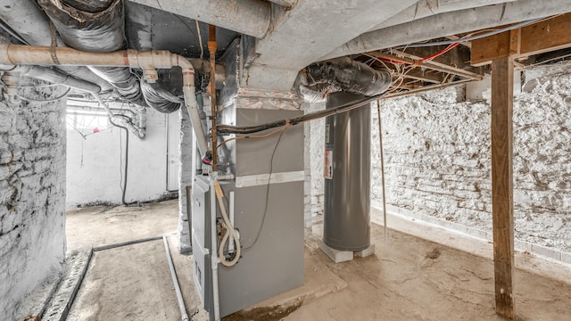 basement featuring heating unit and water heater