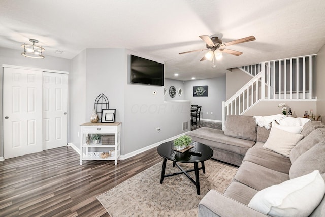 living room featuring a textured ceiling, hardwood / wood-style flooring, and ceiling fan