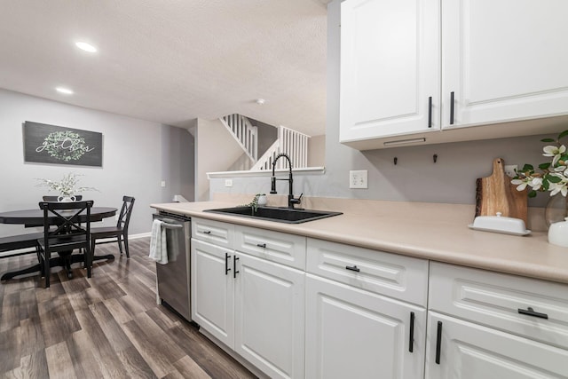 kitchen featuring dishwasher, sink, a textured ceiling, dark hardwood / wood-style flooring, and white cabinetry