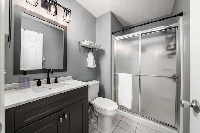 bathroom with tile patterned flooring, vanity, a textured ceiling, and walk in shower