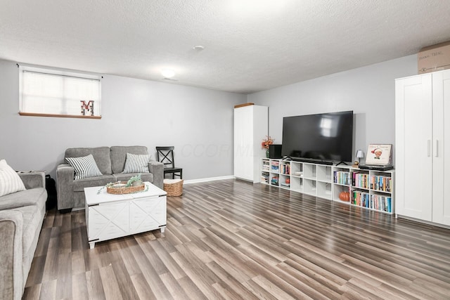 living room featuring hardwood / wood-style flooring and a textured ceiling