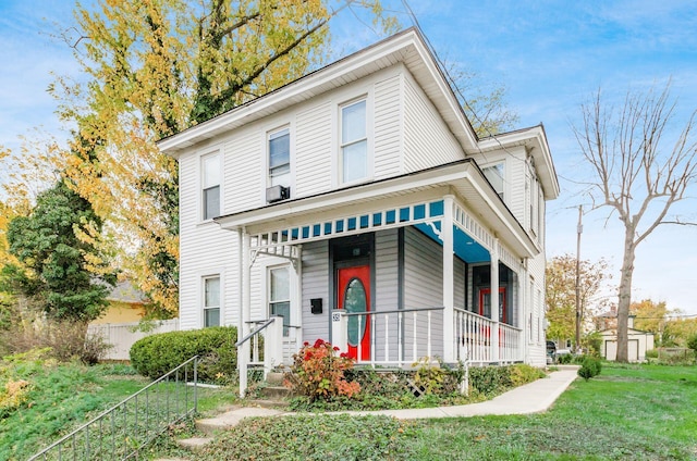 view of front of property featuring covered porch and a front lawn