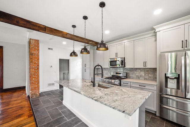 35 E Arcadia Ave, Columbus, OH 43202 - kitchen with stainless steel appliances, recessed lighting, backsplash, a kitchen island with sink, and light stone countertops