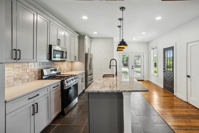35 E Arcadia Ave, Columbus, OH 43202 - kitchen with appliances with stainless steel finishes, recessed lighting, decorative backsplash, french doors, and a center island with sink