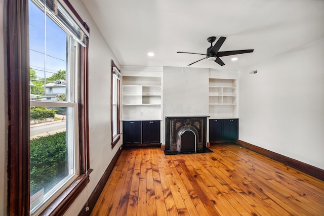 35 E Arcadia Ave, Columbus, OH 43202 - unfurnished living room with healthy amount of natural light, hardwood / wood-style flooring, a ceiling fan, and recessed lighting