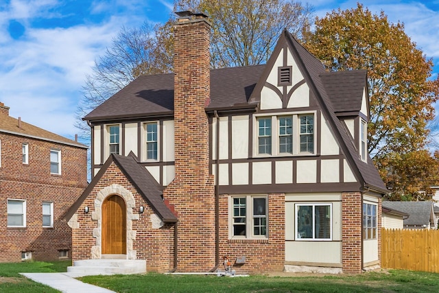 tudor-style house with a front lawn