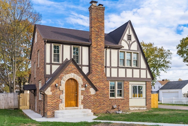 tudor house featuring a front lawn