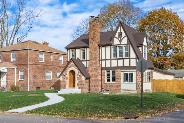 tudor-style house with a front lawn