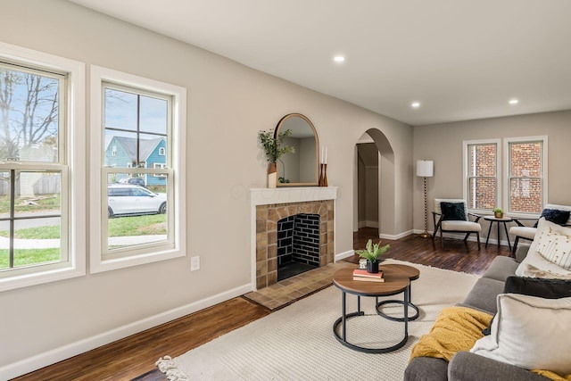 living room featuring a fireplace and dark hardwood / wood-style floors