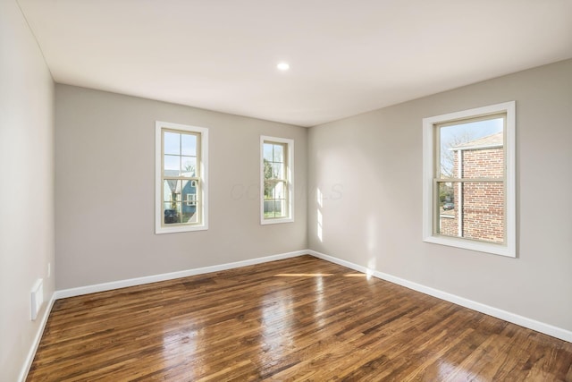 unfurnished room with dark hardwood / wood-style floors