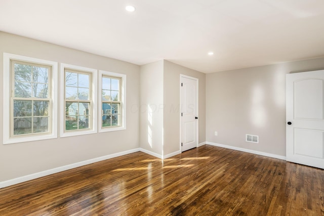 unfurnished room featuring dark hardwood / wood-style flooring