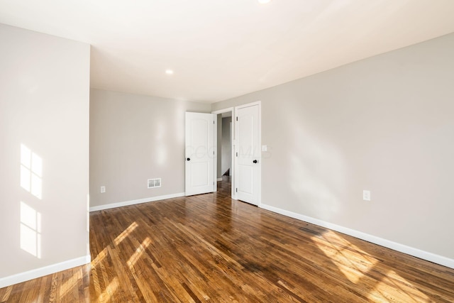 empty room featuring dark hardwood / wood-style flooring