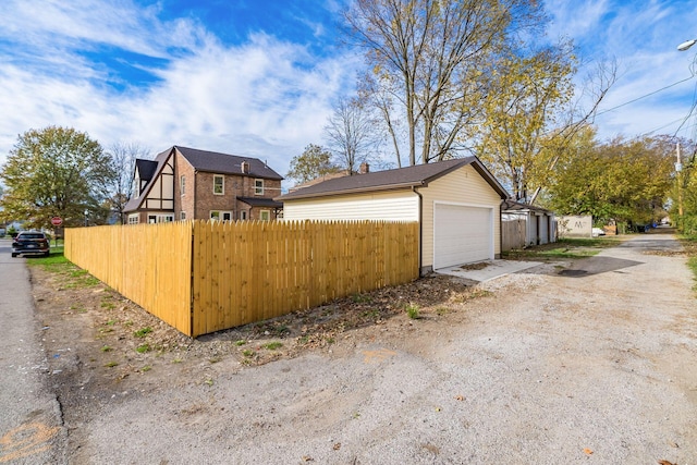 view of home's exterior featuring an outbuilding and a garage