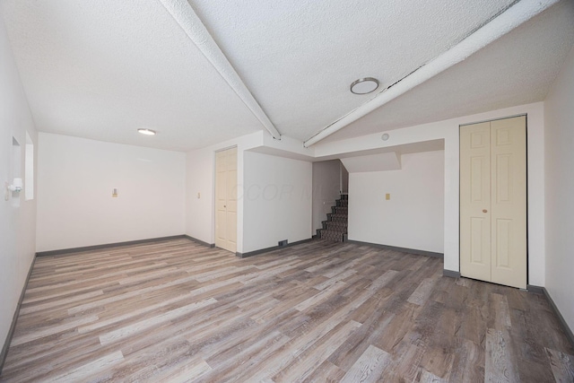 interior space with light wood-type flooring and a textured ceiling