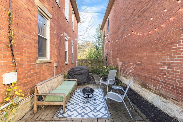 view of patio / terrace with an outdoor fire pit and a grill