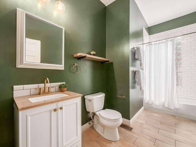 full bathroom with vanity, toilet, shower / tub combo, and hardwood / wood-style flooring