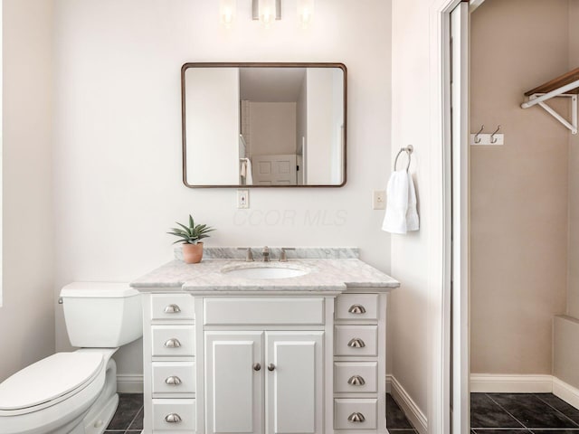 bathroom with tile patterned floors, toilet, and vanity