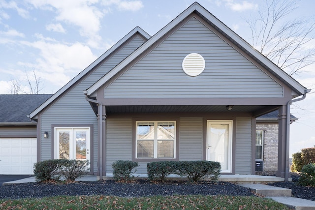 view of front facade featuring a porch and a garage