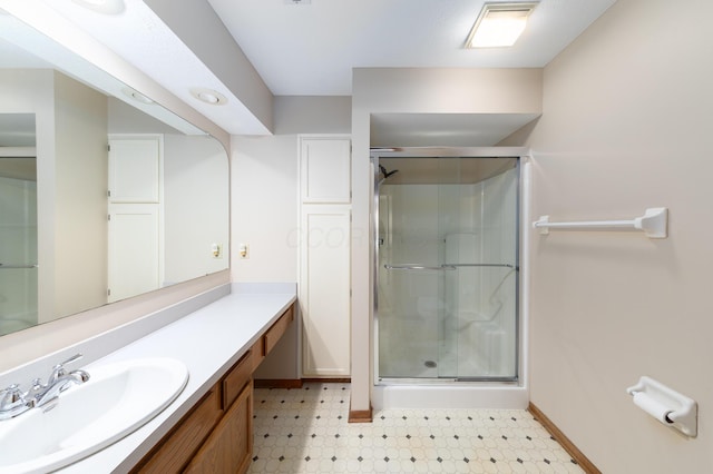 bathroom featuring vanity and a shower with shower door