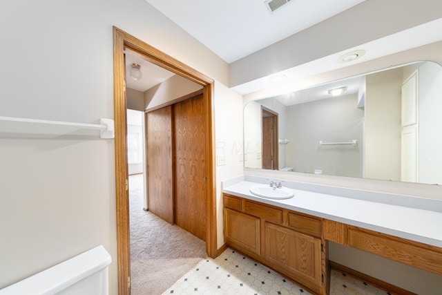 bathroom with vanity and toilet