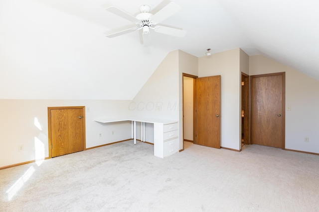 additional living space with light carpet, vaulted ceiling, and ceiling fan