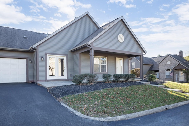 view of front of home with a garage and a front yard