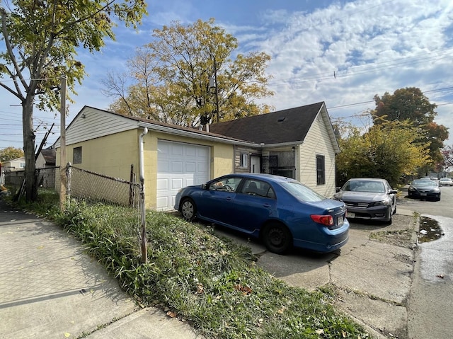 view of side of home featuring a garage