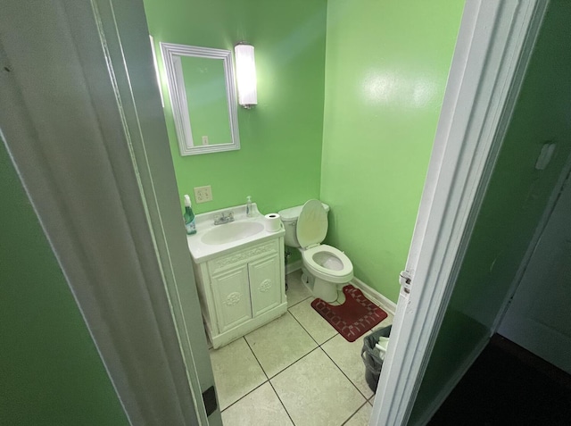 bathroom with tile patterned flooring, vanity, and toilet