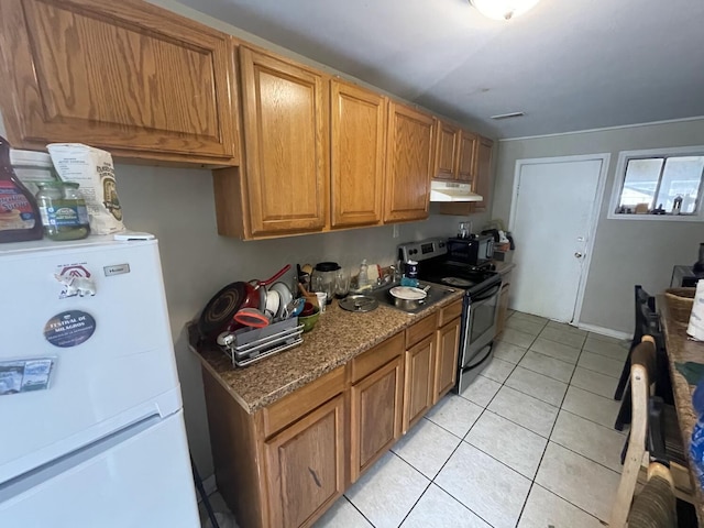 kitchen featuring stainless steel electric stove, sink, stone counters, white fridge, and light tile patterned flooring