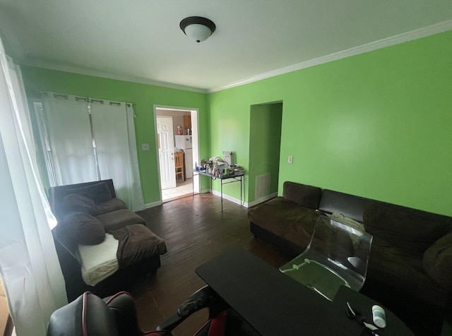 living room with wood-type flooring and ornamental molding