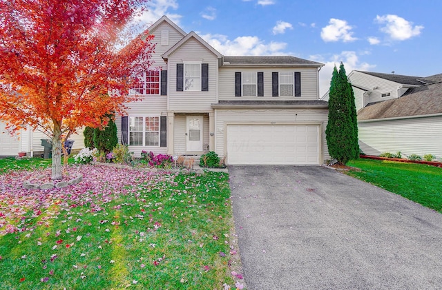 front of property featuring a front yard and a garage