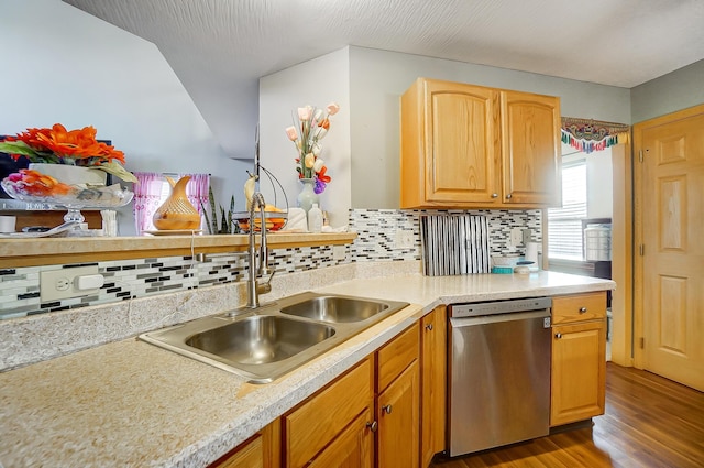 kitchen featuring tasteful backsplash, light hardwood / wood-style flooring, stainless steel dishwasher, and sink