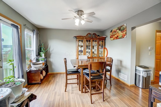 dining area featuring light wood-type flooring and ceiling fan