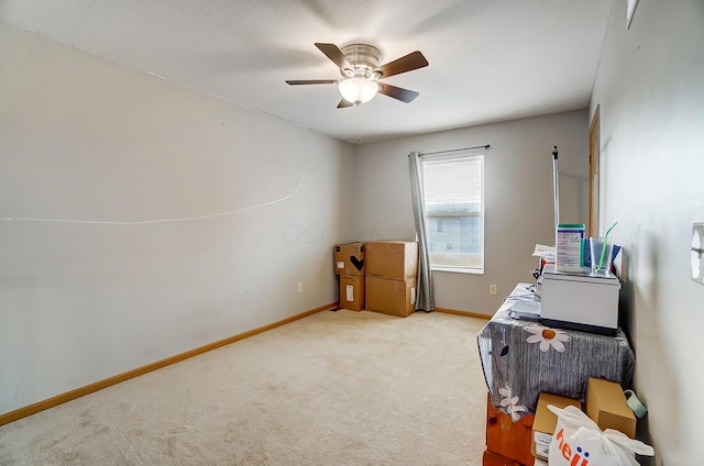 carpeted office space with ceiling fan