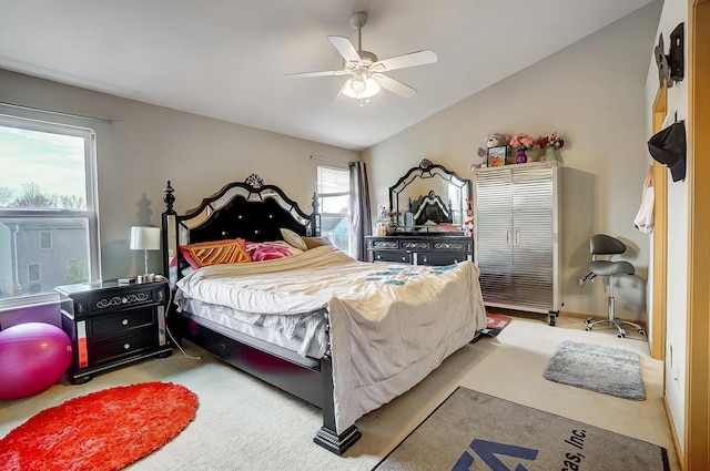 carpeted bedroom with vaulted ceiling and ceiling fan